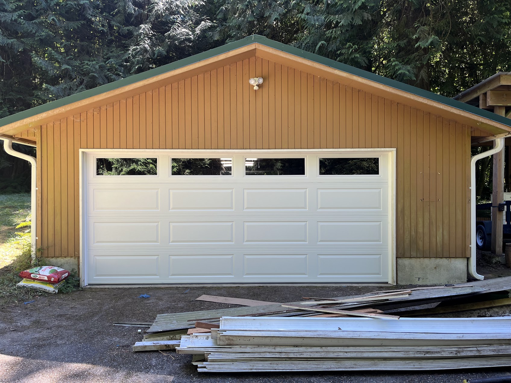 New double-car garage door with windows installed on detached garage in Kirkland, WA