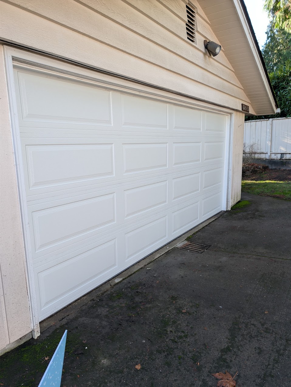 Double-car traditional panel garage door replacement in Redmond, WA