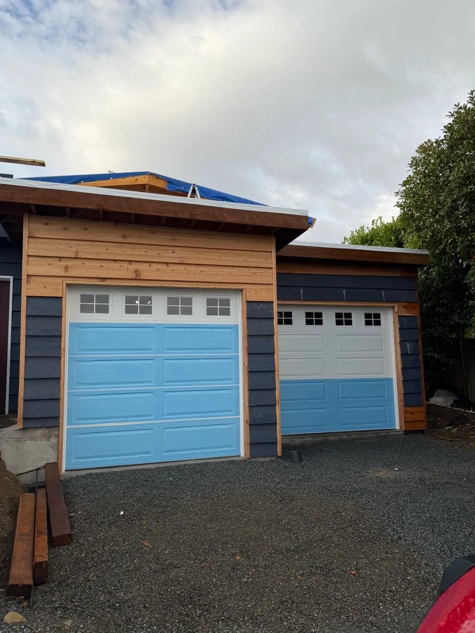 The same Des Moines garage with two new garage doors installed on the finished openings