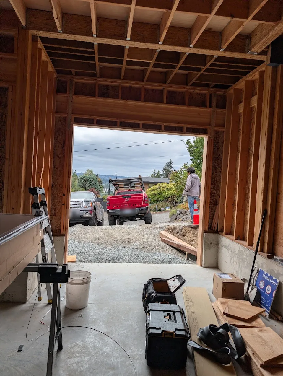 Inside the framed Des Moines garage looking out through the empty door opening