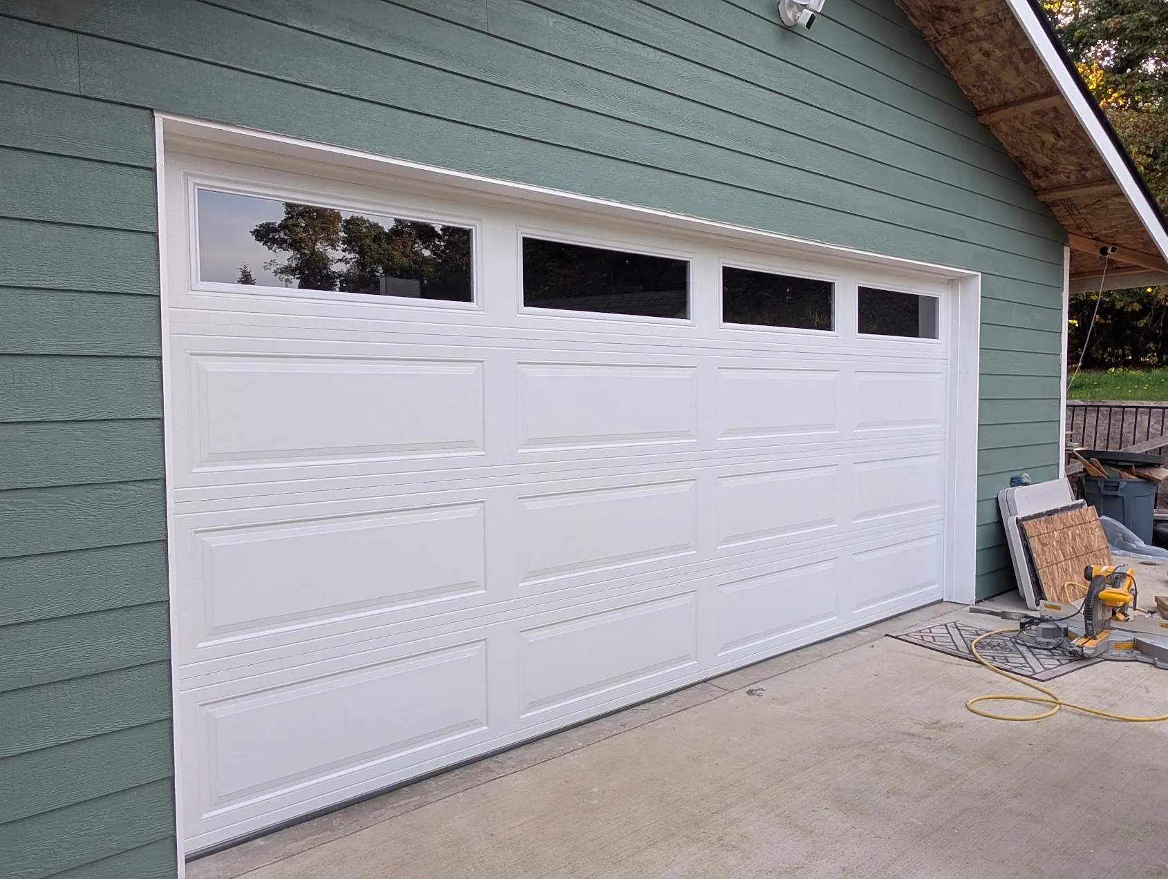 Finished white raised panel garage door with a row of windows on a Federal Way detached garage