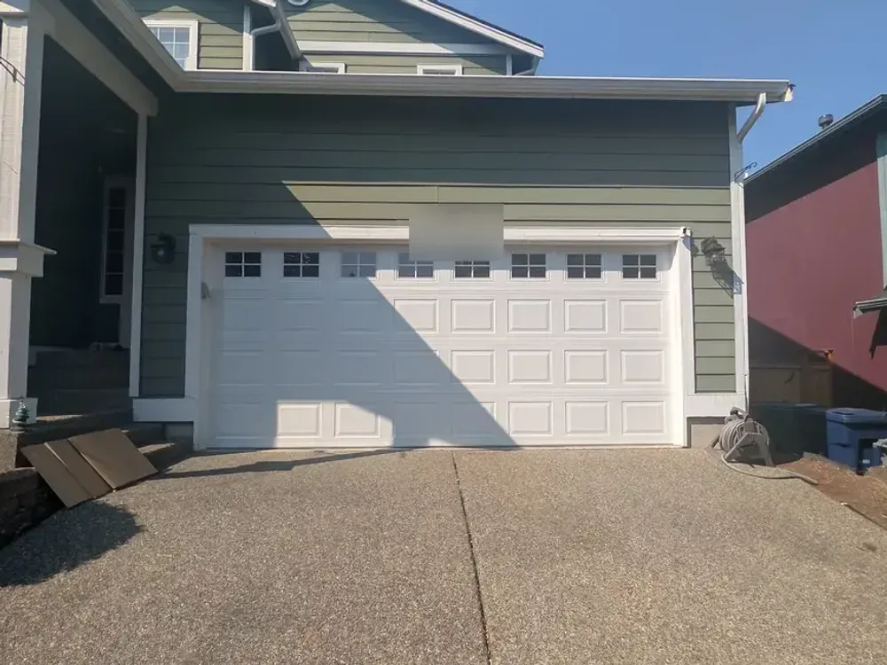After: the same Lynnwood opening fitted with a new white raised-panel garage door with a matching window row.