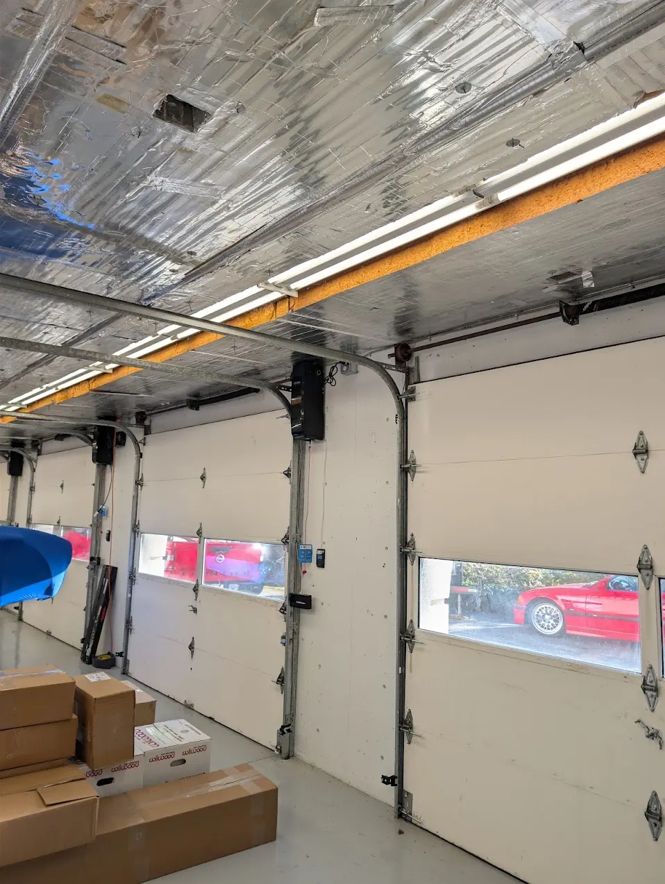 Four LiftMaster wall mount openers installed one per bay in a concrete four bay garage in Shoreline
