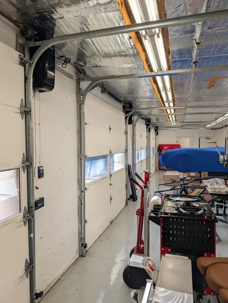 LiftMaster wall mount garage door opener and wall console installed beside a door in a Shoreline concrete garage